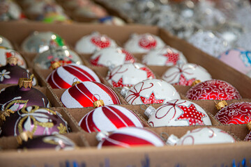 European Christmas market stall in  Old Town. colorful Christmas ornaments are some of the most popular souvenirs with tourists at seasonal fairs.