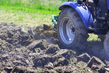 Tractor ploughs land in autumn in preparation for spring planting farming