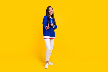 Full body size photo of excited brunette hair funny woman directing forefingers cool event for you isolated on yellow color background - obrazy, fototapety, plakaty