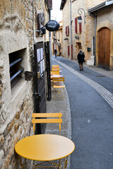 Colorful outdoor cafe table and chairs along the street