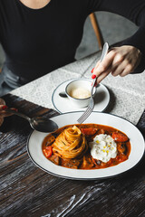Appetizing pasta with tomato sauce and cheese on a dark wooden table. Restaurant food service.