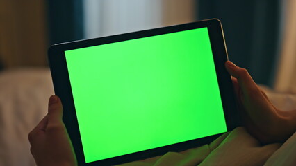 Closeup green screen tablet in hands home. Night person watch chromakey online