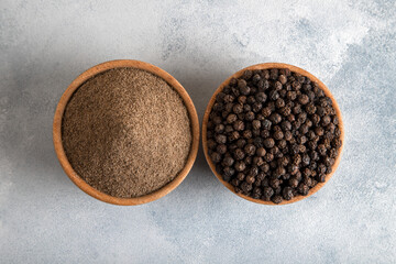  Ground black pepper with grains of black pepper on bright background 