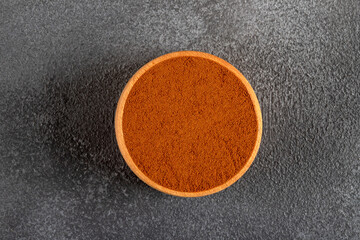 A bowl of ground coffee on a dark background,top view