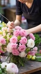 Florist at work in his studio. A flower shop worker creates a bouquet.
