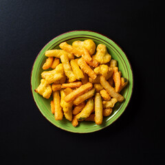 top view plate with battered vegetables on black background