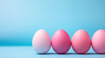 Fototapeta premium Four Easter light pink eggs on a blue background, with space for text