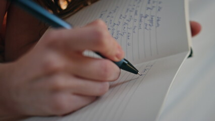 Hands making diary notes closeup. Happy smiling girl holding pen writing plans