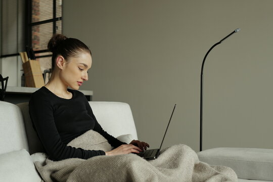 Young freelancer working from home on her laptop computer
