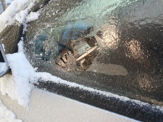 Ice broken on the side window of a car.