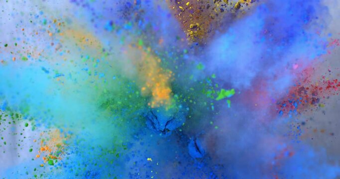 Super slow motion close up of flying rainbow colors powder particles explosion isolated on black background at 1000 fps.