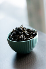 Cut Black Olives in Small Blue Bowl on Table - Savory Mediterranean Delight
