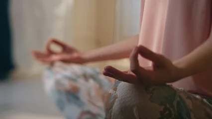 Küchenrückwand glas motiv Closeup girl hands meditating in lotus position. Serene person practicing mudra © stockbusters