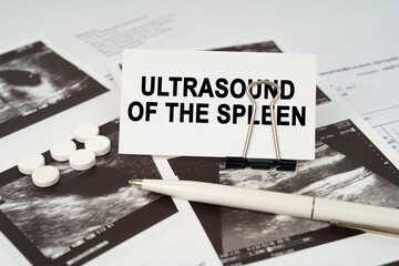 On the ultrasound pictures there is a pen and a business card with the inscription - Ultrasound of the spleen - obrazy, fototapety, plakaty
