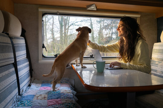 Woman traveling in a motorhome with her dog