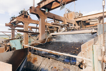 Fototapeta premium Sand quarry banner, Industrial plant with belt conveyor in open pit mining. Construction site, Industry machine for stone crusher