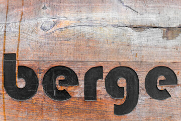 A wooden inscription mountains in German - 705800907