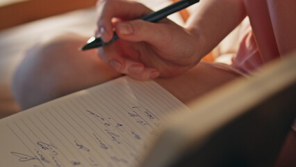 Hand making handwriting notes closeup. Girl holding pen planning day in morning.