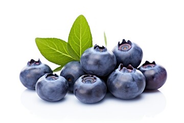  a pile of blueberries with a green leaf on top of the blueberries is on a white surface and is ready to be used as a garnish.