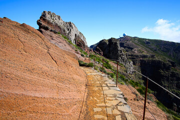 Fototapeta na wymiar Walking trail at the Pico do Arieiro mountain peak on Madeira island, Portugal - Paved footpath for hikers visiting the third highest mountain of the island