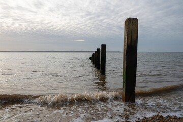 waves by the groynes at Browndown Hampshire England