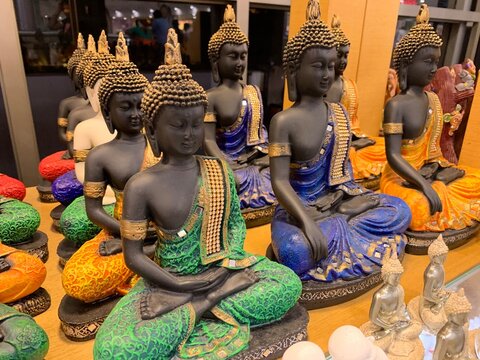 statue of buddha with different colors