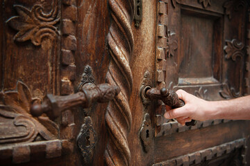 Fototapeta na wymiar Beautiful carved wooden door being opened. 