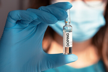 A doping ampoule in a nurse's hand - obrazy, fototapety, plakaty