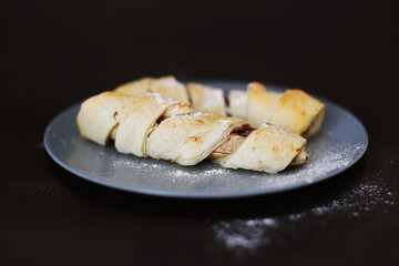 homemade bananas in dough on a black background
