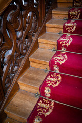 Ornate carved wooden staircase.
