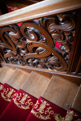 Ornate carved wooden staircase.