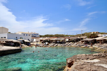 Main view of "Es Caló" fishermen bay, with white village houses on background, Formentera, Balearic Islands, Spain.