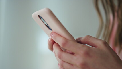 Closeup hands swiping smartphone in dark room. Unknown girl check social media