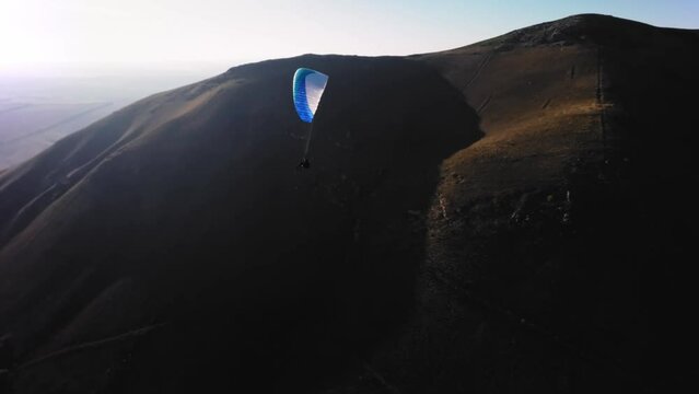Aerial view. Chasing a hang glider in the air. Unique aerial photographs of extreme sports shot on a sports fpv quadcopter