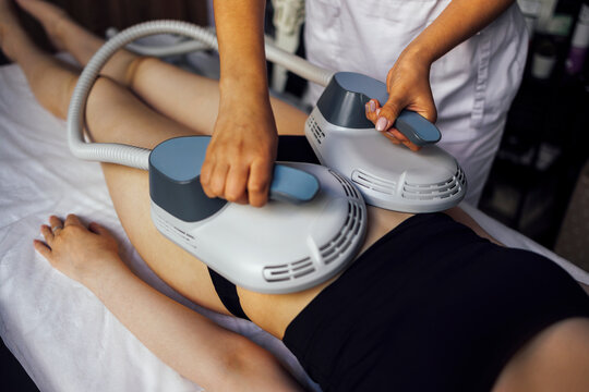 Woman getting treatment on buttocks to burn fat, build muscles and remove cellulite.