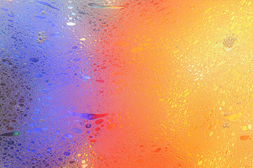 Macro shot of water-oil emulsion over colored background - obrazy, fototapety, plakaty