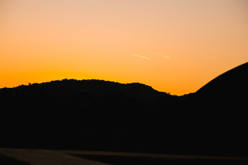 Background from a beautiful colorful sunset with the silhouette of the mountains. High quality photo