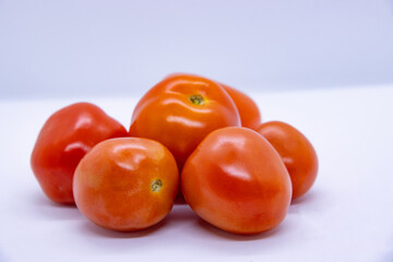 Red shiny fresh tomatoes in isolated White Background