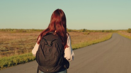 girl traveling with backpack sunset, family sun, hiking girl asphalt road, youth happiness, trekking, raises her hands air, happy woman running sunset, happy student, lifestyle, hipster millennial