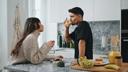 Romantic newlyweds enjoying breakfast kitchen. Positive lovers speaking closeup