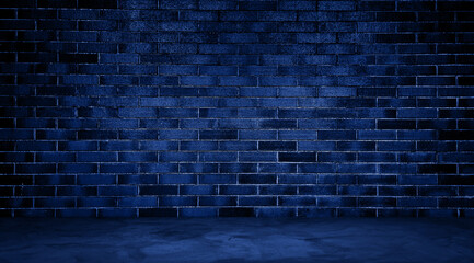 dark room with blue concrete floor and blue brick wall background. empty room for montage product displayed in rustic, industrial, loft mood and tone. room interior with blue light for design.