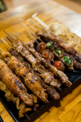 Variety of meat skewers on dish