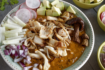 Vegan Pozole topped with fresh vegetable ingredients. Mexican cuisine homemade food with jackfruit instead of meat...