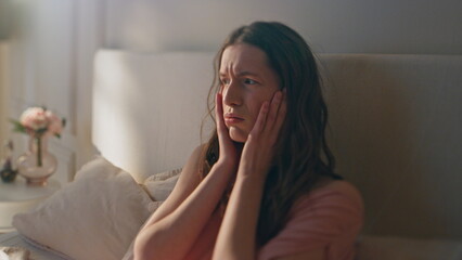 Dizzy girl feeling headache in morning closeup. Frustrated woman suffer hangover