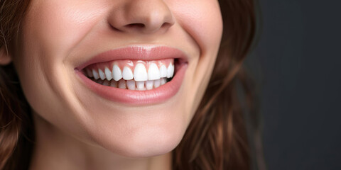 Obraz premium Banner with close-up of a beautiful smiling woman with white perfect teeth isolated on dark black.