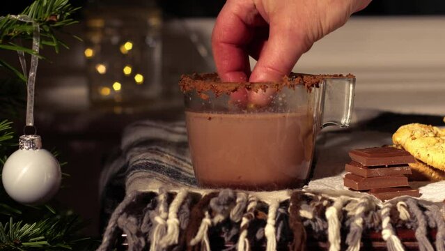 Dunking cookie in Hot Chocolate drink in Christmas festive scene 