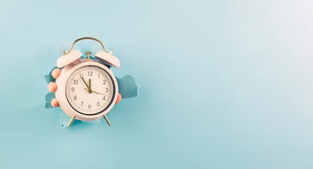 Foto op Plexiglas Hand holding alarm clock, torn paper hole, time management, reminder and planning, finish a deadline, timetable and stress, countdown  © Berit Kessler