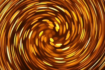 Gold caramel colored twirl spiral abstract. Twirled vortex as colorful abstract background made of golden, brown chrome and bronze glossy curve tubes on black. Magic fiery light spiral effect