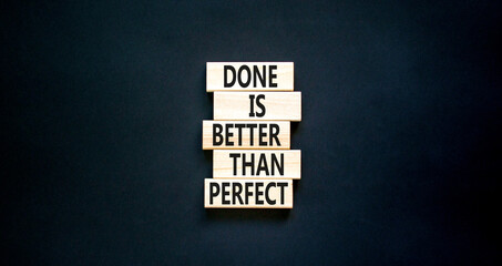 Done is better than perfect symbol. Concept words Done is better than perfect on wooden blocks. Beautiful black table black background. Business, done is better than perfect concept. Copy space.