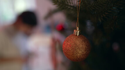 Christmas ball decoration hanging on tree during winter season holidays, celebrating tradition